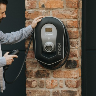 Electric vehicle charger installed on an outside wall